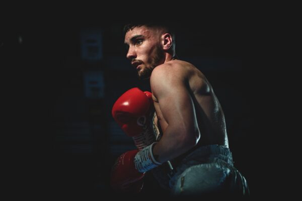 Boxer performing a shell-guard, while wearing boxing gloves