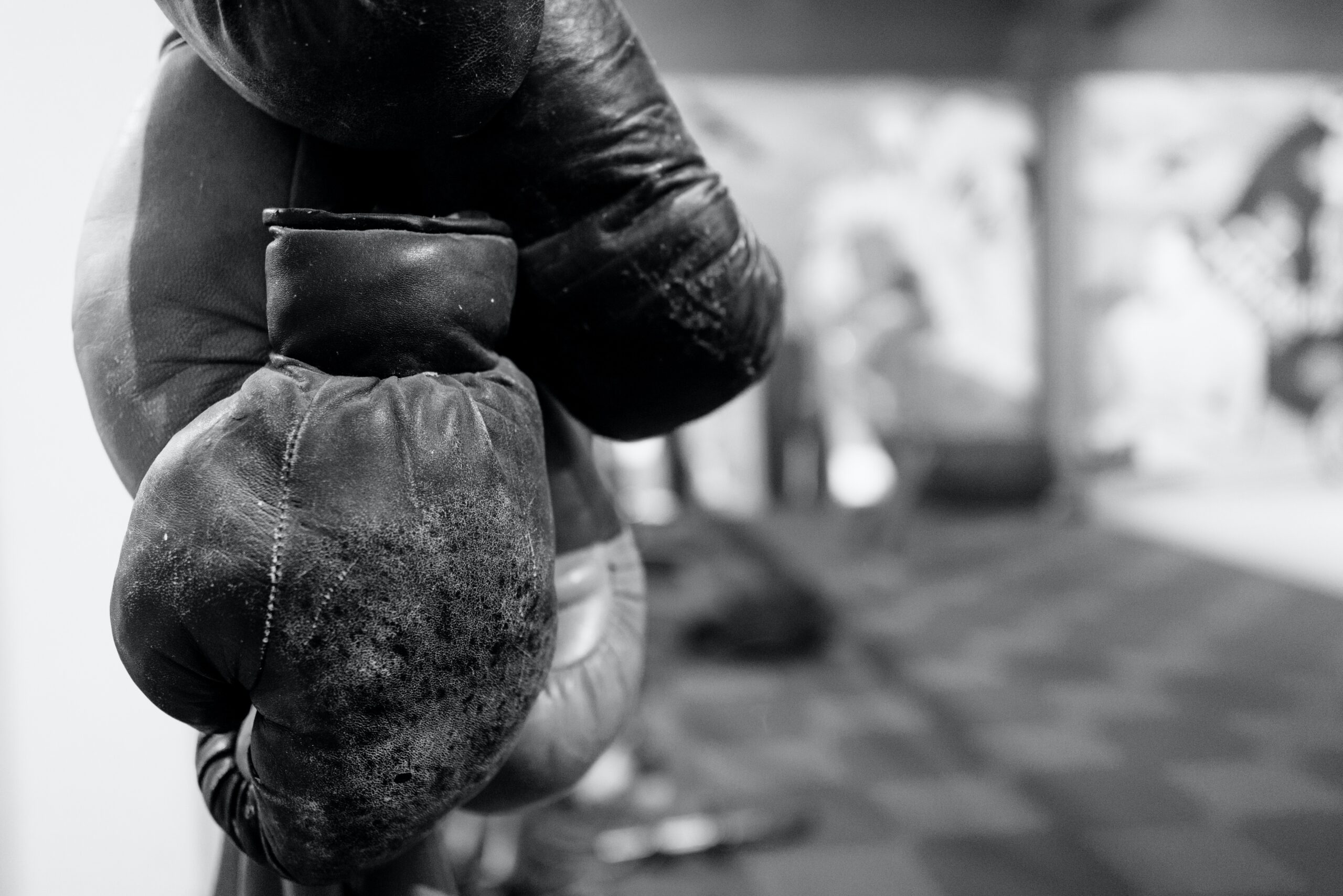 A pair of boxing gloves hanging in a boxing gym