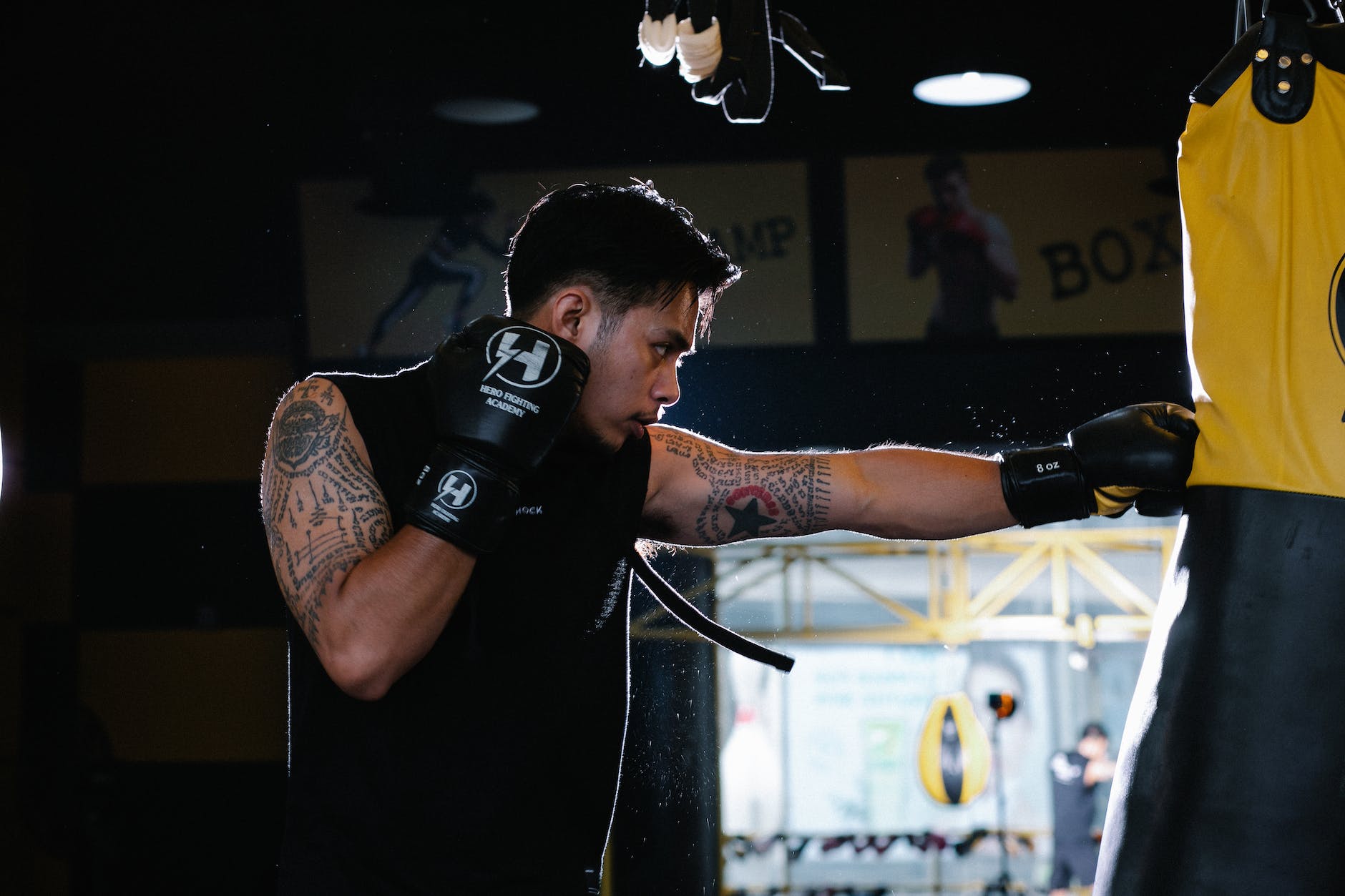 athlete hitting heavybag while practicing boxing