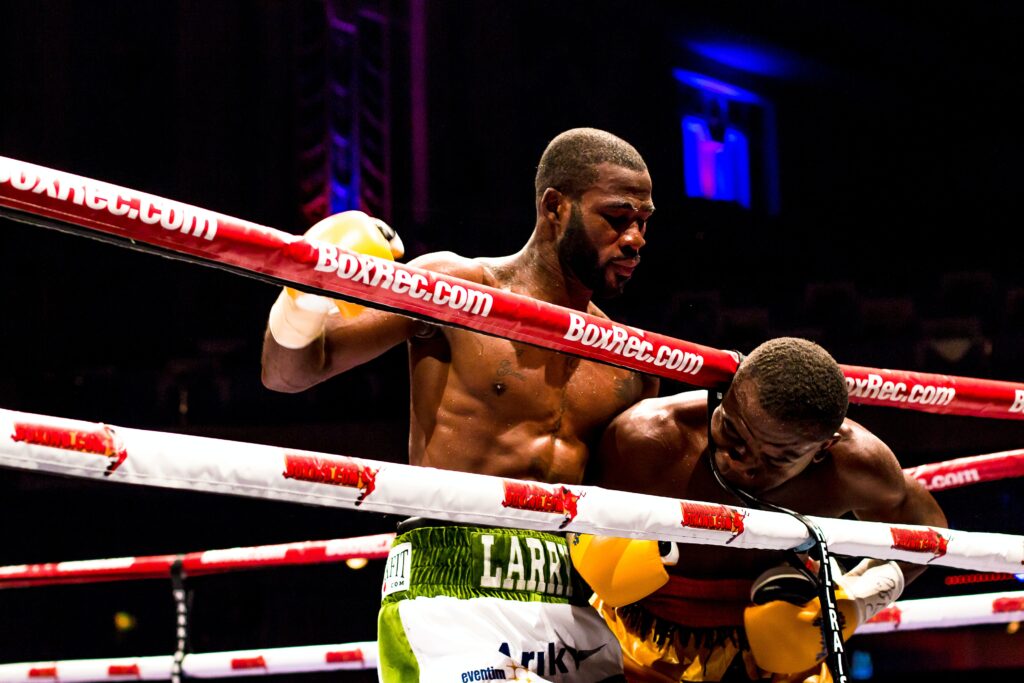 Boxer doing a rabbit punch on a opponent.