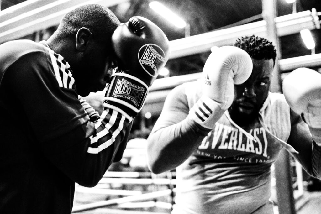 2 men sparring. Boxing gloves, boxing defense, boxing gym