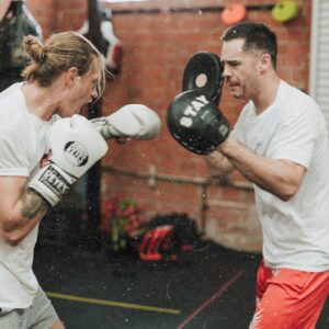 boxer practicing feints with boxing coach