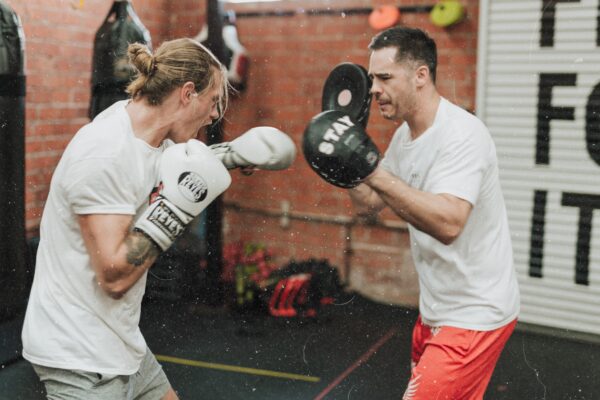 boxer practicing feints with boxing coach