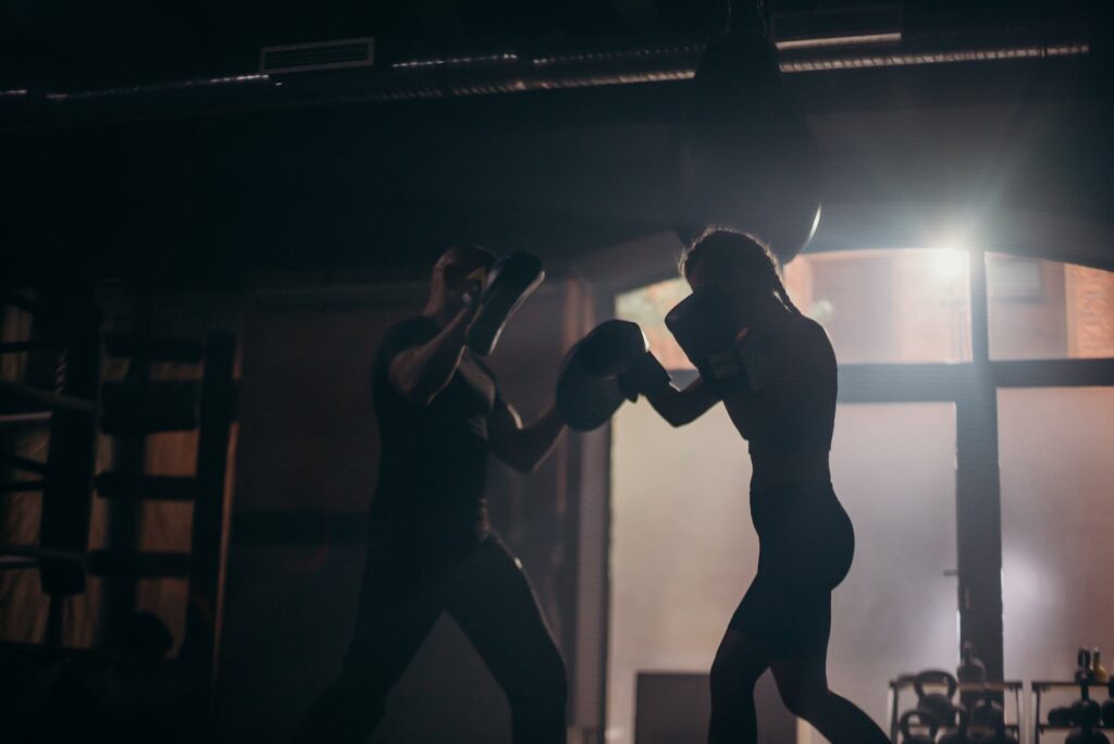 boxing without a heavy bag. Boxer hitting focus mits with boxing gloves