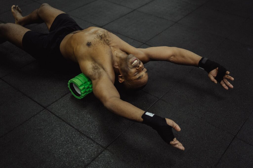 man foam rolling. Recovery for amateur boxer