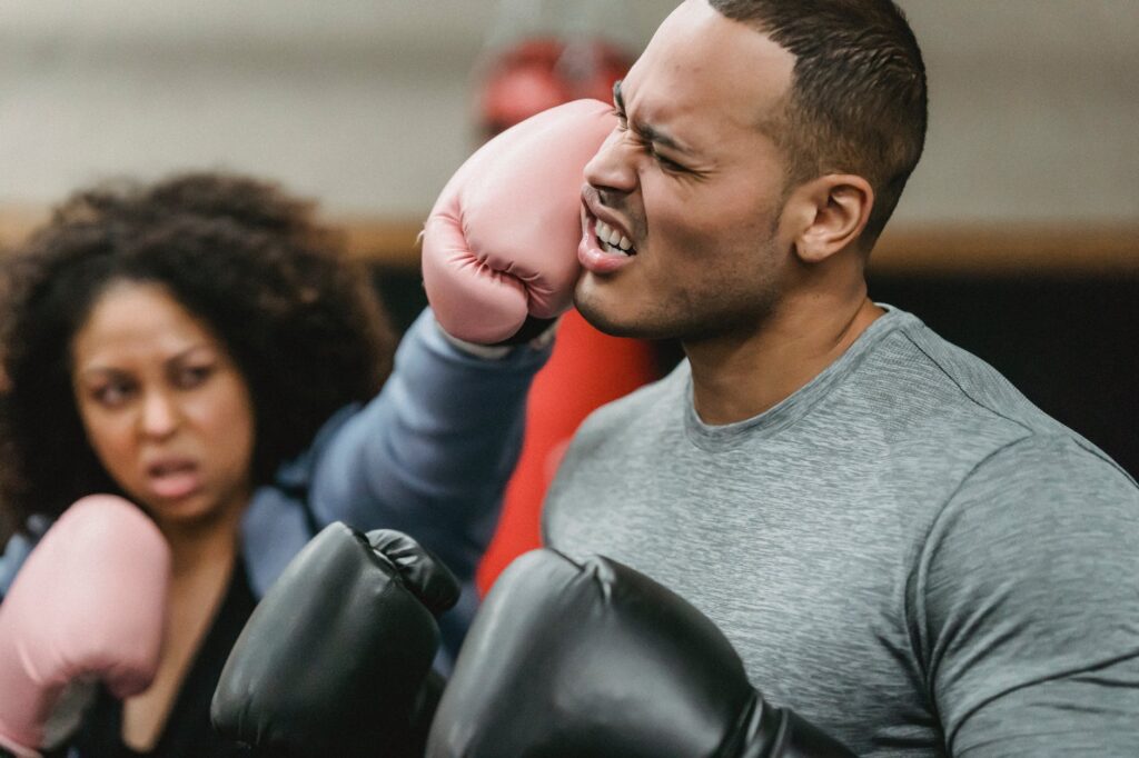 woman punching man with boxing glove. Boxing statistics