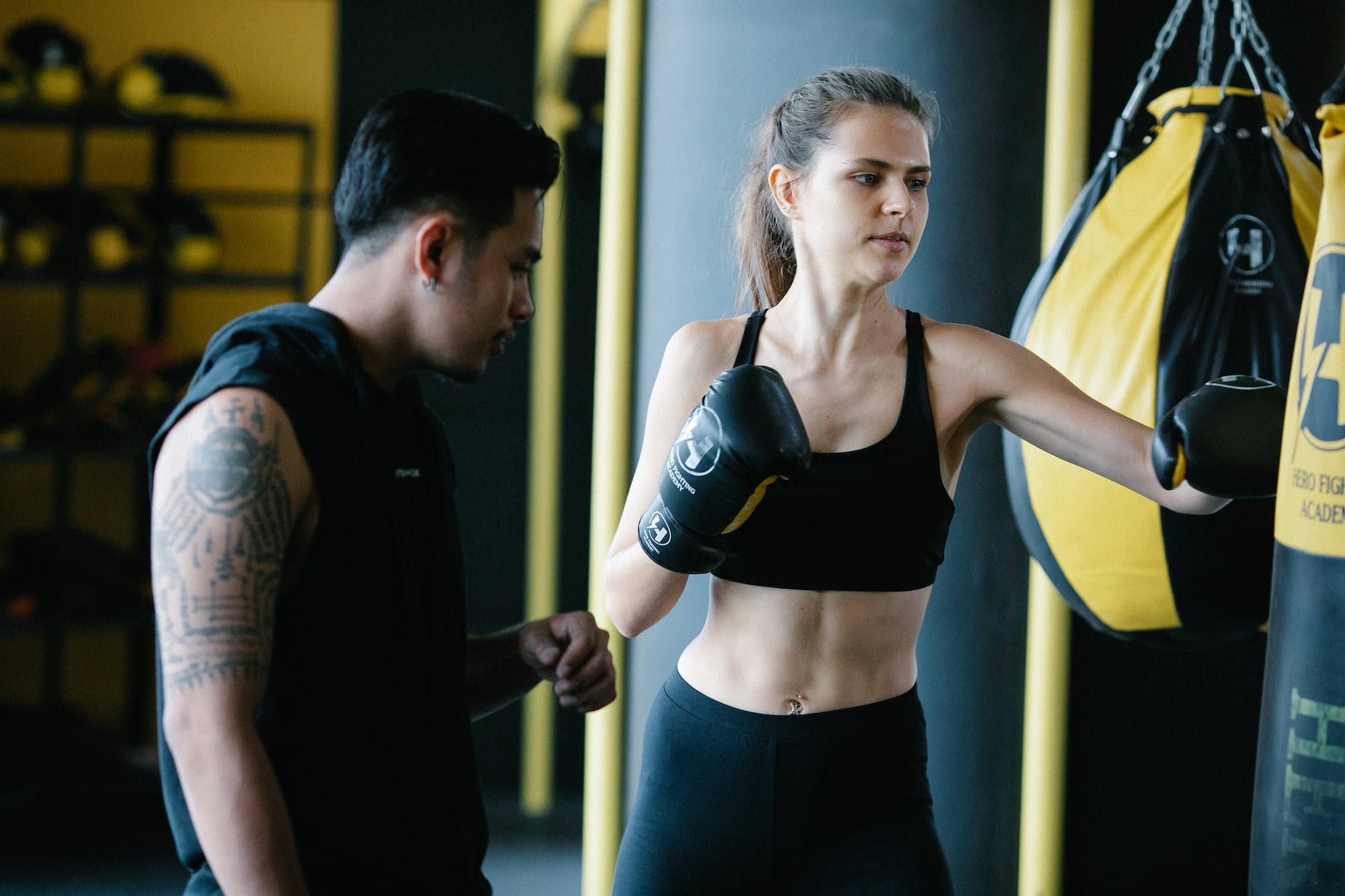 coach training woman to do boxing. Beginner boxer listens and learns