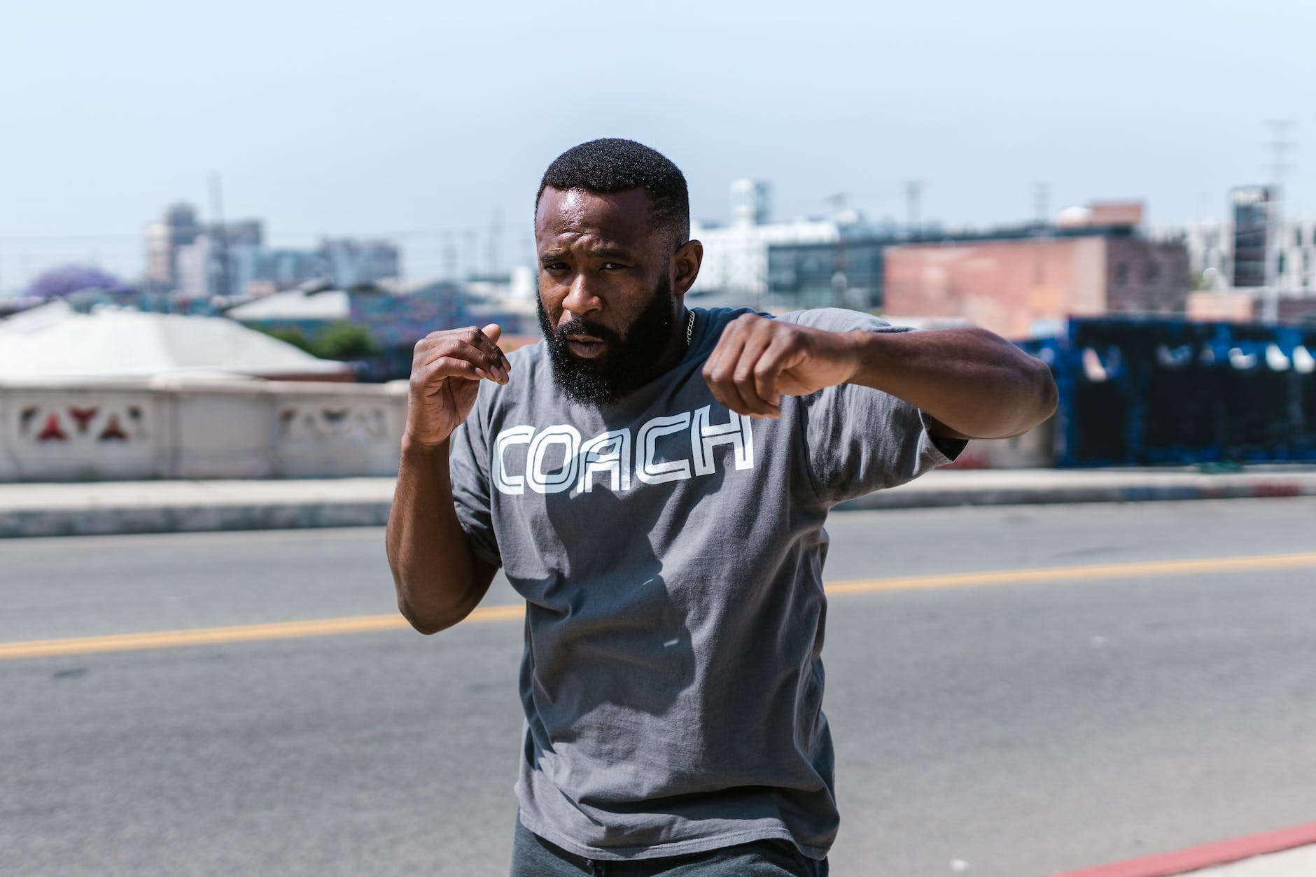 man in gray shirt shadow boxing