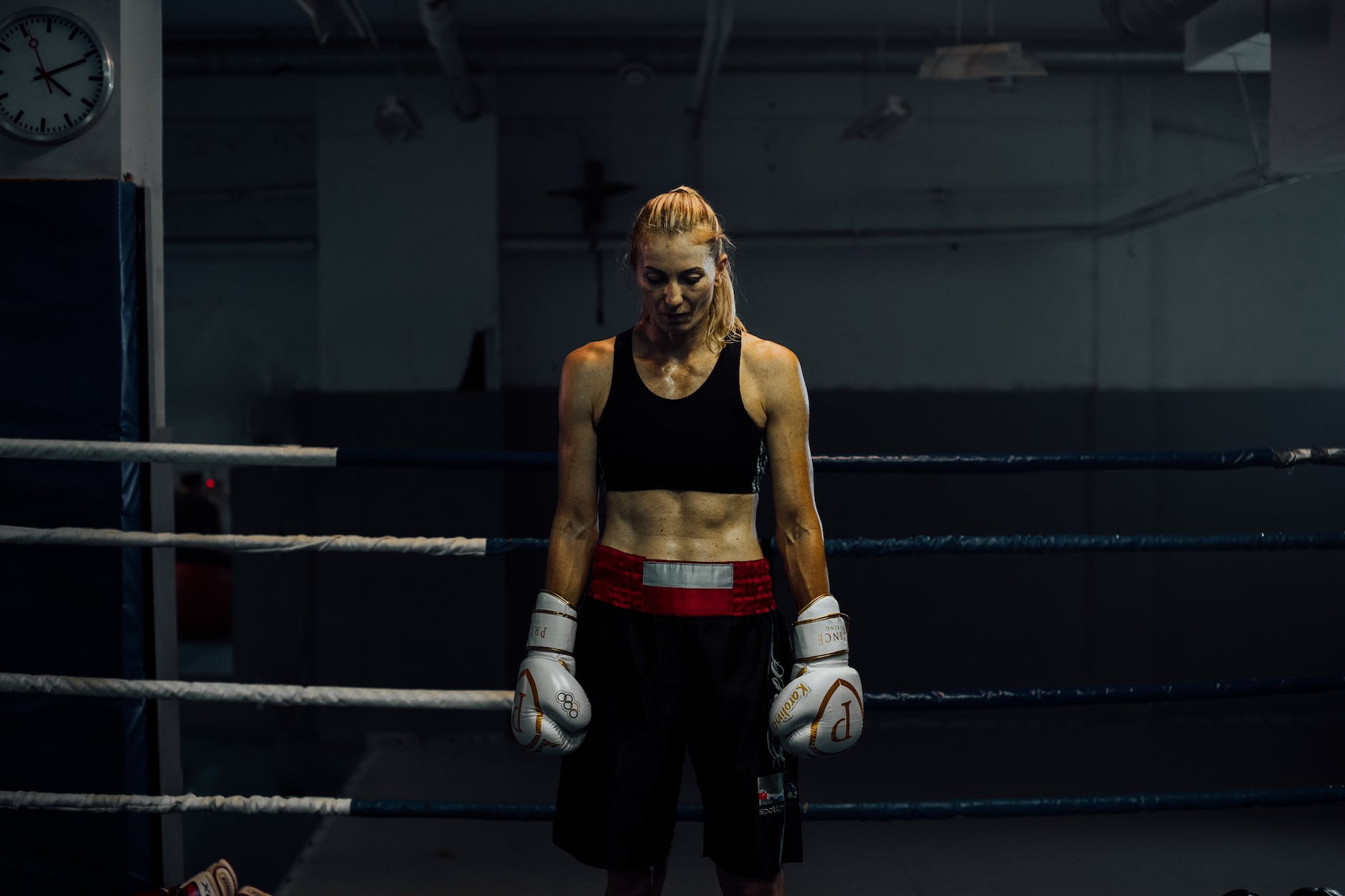 woman in a boxing ring wearing boxing gloves. 